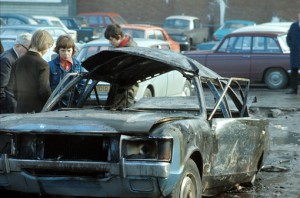 Children play in burnt out vehicles, August (1971, BBC)