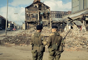 Two British soldiers stand in front of a ruin (1969, BBC)